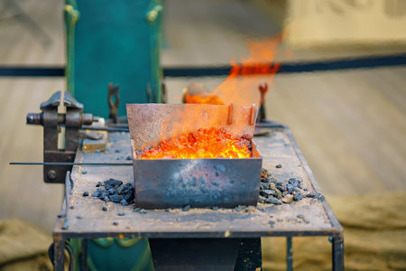 Blacksmiths forge with burning fire and red coalsの写真素材