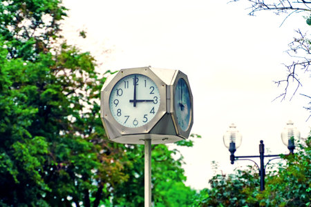 A street clock with hands shows exactly three o'clockの写真素材