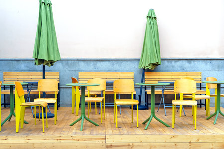 Tables and chairs of a street restaurant after the rainの写真素材