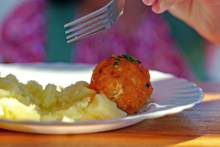Meat meatballs with mashed potatoes on a white plateの写真素材