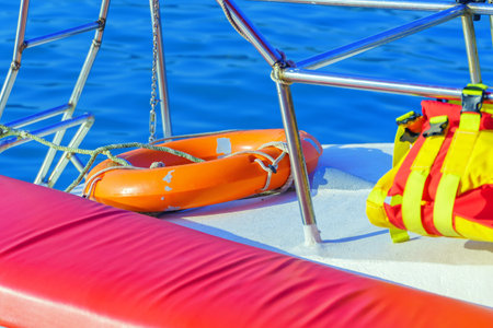 Plastic lifebuoy and life jacket on board a pleasure yachtの写真素材