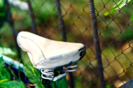 The vintage leather bike seat is painted whiteの写真素材