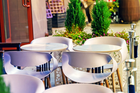 White round tables in a street restaurantの写真素材