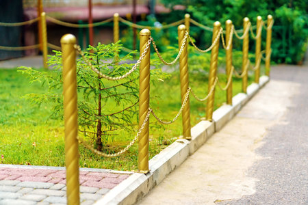 Decorative fence with golden-colored chainsの写真素材