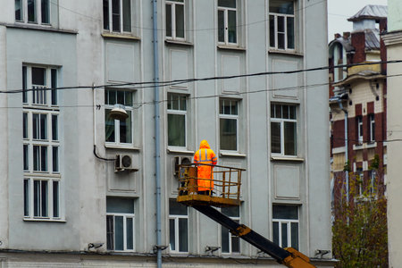 Worker on a construction site on a background of an apartment building