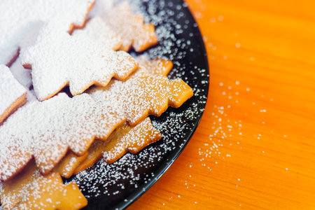 Christmas tree cookies sprinkled with powdered sugar