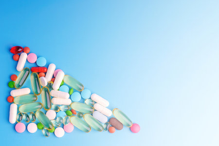 Colorful pills in the shape of a triangle on a blue background