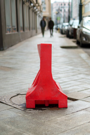The manhole is covered with a red sign for safetyの写真素材