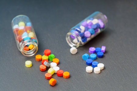 Two glass bottles amidst scattered, colorful wax hexagon seals