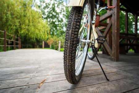 leisure bicycle parked on a kickstand on a wooden pier near the forest, inviting a peaceful ride amidst nature's serenityの写真素材