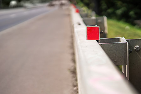 red reflective catadioptrics on road guardrails, symbolizing safety and visibility for drivers, enhancing nighttime road awareness and accident preventionの写真素材