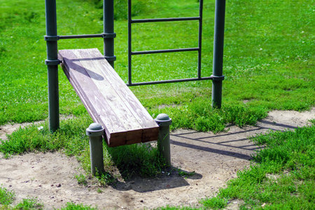 outdoor fitness bench, designed for strength training. Set in a vibrant community space, it promotes...