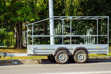 empty cargo truck trailer rests on the roadside, reflecting the solitude of transportation. Its...
