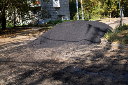 vibrant patch of black asphalt sits on a bustling city street, symbolizing both the disruption of...