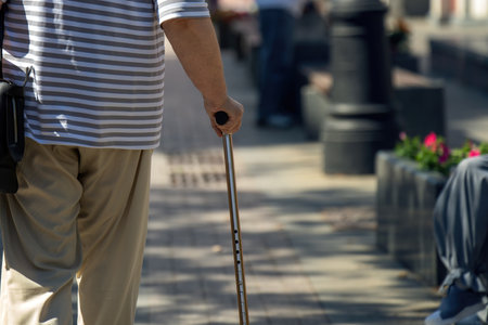 wise old man grips a sleek, adjustable metal cane, symbolizing adaptability and resilience. The canes height reminds us that age is just a number, and one can rise above challengesの写真素材