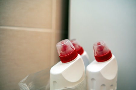tops of several cleaning bottles, designed for sanitizing toilets and plumbing. Bright colors and unique shapes emphasize their purpose in household hygieneの写真素材