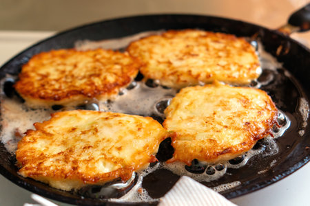 Zucchini fritters sizzle in a skillet, golden and crispy, embodying the essence of healthy comfort...