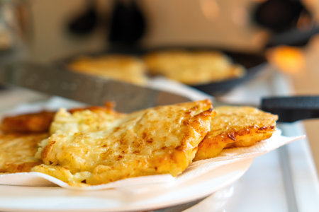 Golden-browned zucchini patties elegantly arranged on a plate, showing a crispy texture and vibrant...
