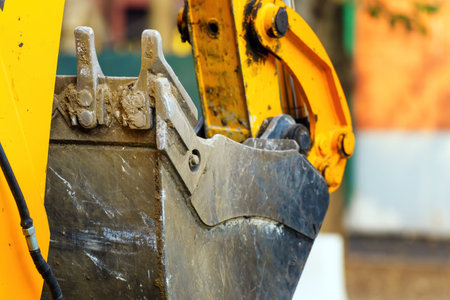 worn teeth of an excavator bucket, reflecting the relentless impact of heavy-duty excavation work, embodying strength, durability, and the marks of laborの写真素材