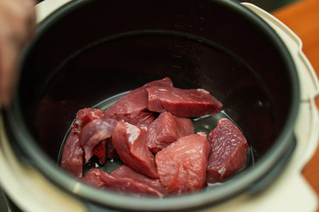 Tender pieces of beef slowly simmer in a pressure cooker, infused with rich flavors. The steam rises, promising a satisfying meal that embodies comfort and warmthの写真素材