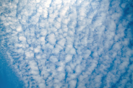 Wispy cirrus clouds stretch across the sky, creating ethereal patterns. Their delicate formations...