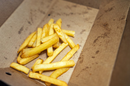 half-eaten cardboard box of French fries