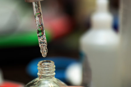 clear glass dropper filled with a viscous transparent liquid, perfect for cosmetic procedures. Ideal for skincare, beauty treatments, and spa applicationsの写真素材