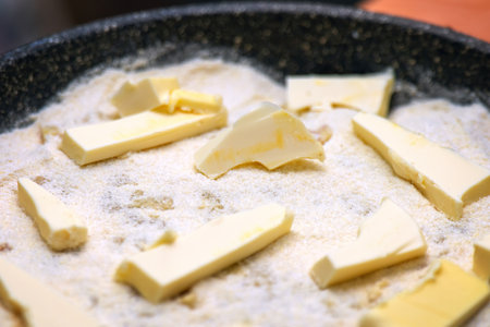 homemade raw apple pie in a baking dish, topped with generous chunks of butter, ready for baking. The pie features a flaky crust and fresh apple filling, perfect for dessertの写真素材