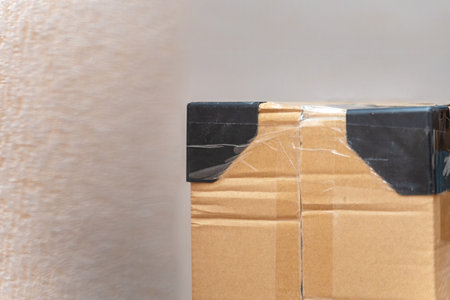 Cardboard box with plastic corner protectors for secure shipping and product protection, ideal for logistics and packaging concepts.の写真素材