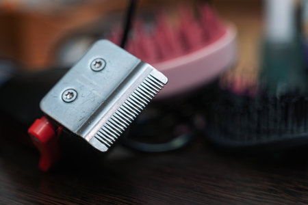 Bottom view of hair clipper with metal blades on dark background, ideal for grooming product photography and barber equipment ads.の写真素材