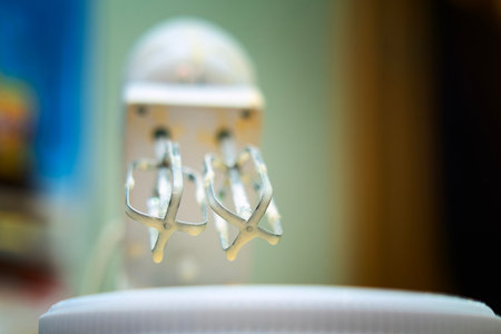 Whisk attachment raised after mixing, with fresh dough traces.の写真素材