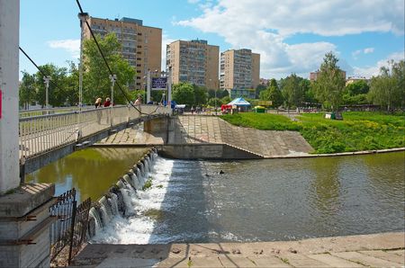 Suspension bridge above the back river in cityの写真素材