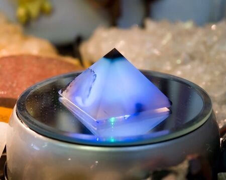 Small magic pyramid on a mirror supportの写真素材