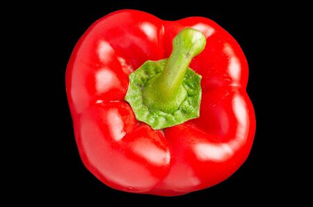 Red sweet pepper with a green cutting on a black backgroundの写真素材