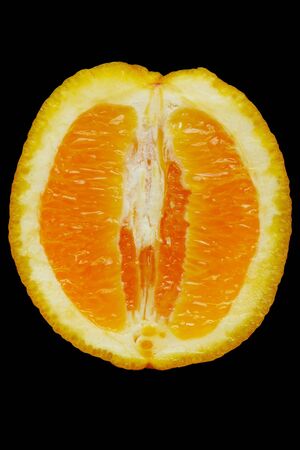 Half of juicy orange against the black backgroundの写真素材