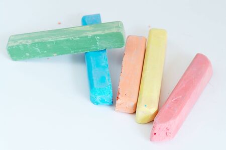 many-colored children's chalks against the white backgroundの写真素材