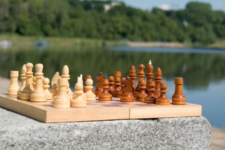 the chessboard with the figures with river at background