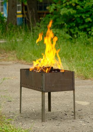 small road mangal with the burning firewoodの写真素材