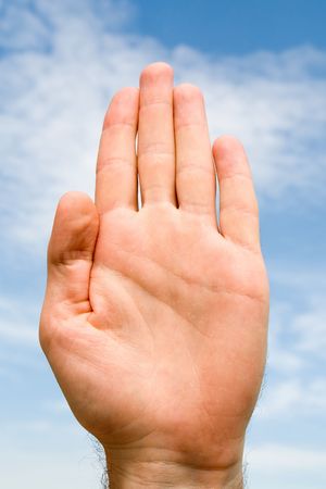 oath. hand gesture with blue sky at backgroundの写真素材