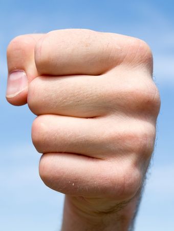 fist. hand gesture with blue sky at backgroundの写真素材