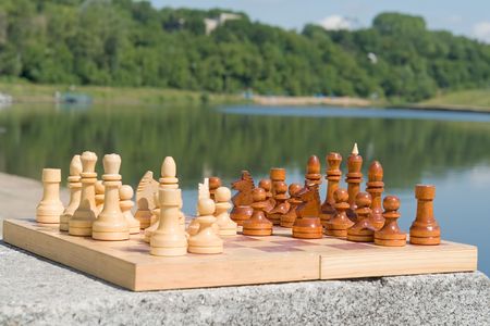 the chessboard with figures with river at backgroundの写真素材