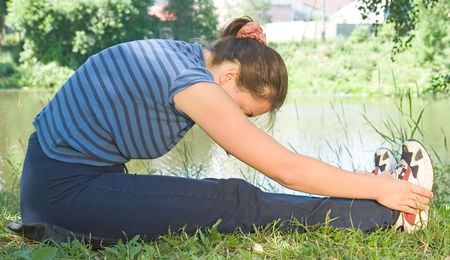 Woman is trained on a riversideの写真素材