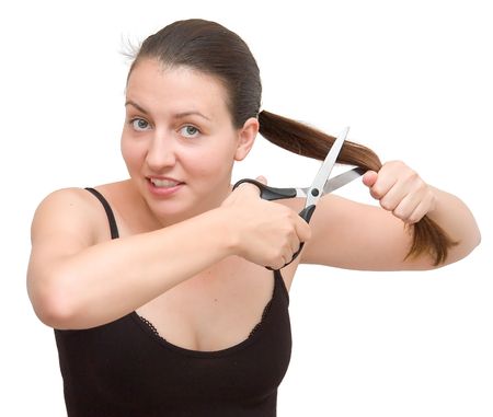 The young woman cuts off the hair on a white backgroundの写真素材
