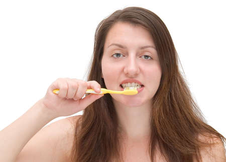 Beautiful girl about to brush her teeth, close up, isolated on whiteの写真素材