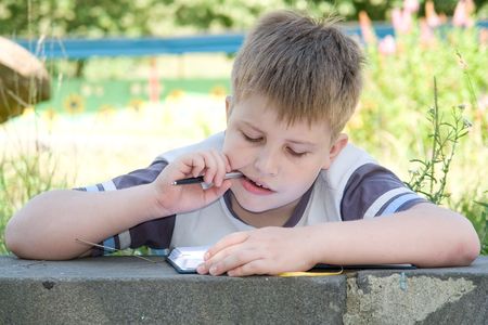 The little boy writes to writing-booksの写真素材
