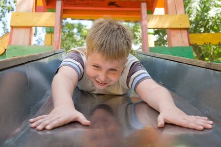 The little boy on a chute in city parkの写真素材