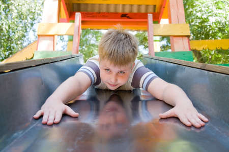 The little boy on a chute in city parkの写真素材