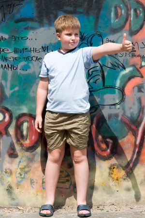 A smiling child with graffiti at backgroundの写真素材