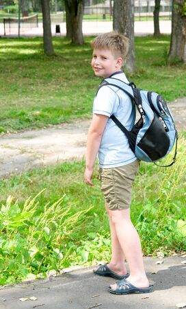 The little boy with a backpack in green parkの写真素材