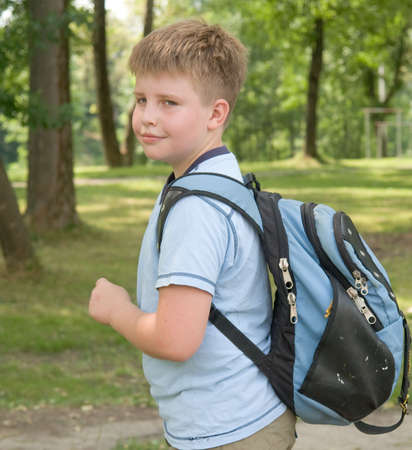 The little boy with a backpack in green parkの写真素材